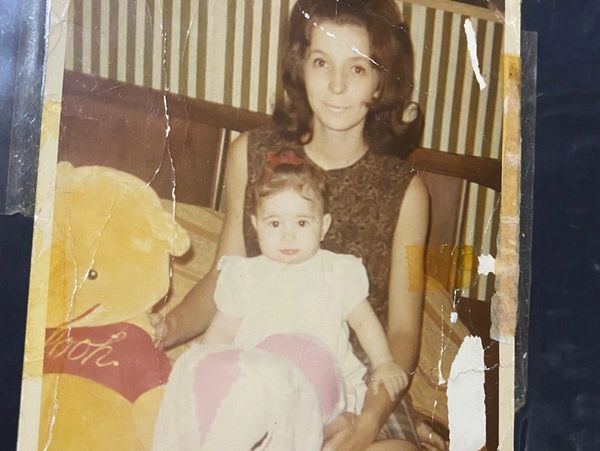  In 1966, Kate lovingly holds her daughter Ruth, just months old, with Winnie the Pooh beside them.