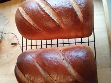 2 loaves of italian bread cooling on a wire rack