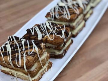 French napoleons layered with pastry cream and drizzled with chocolate