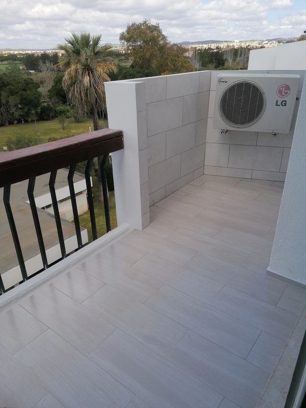 Balcony with air conditioner and scenic view.
