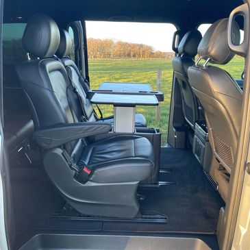 Luxury leather seats with fold out tables and drinks holders.