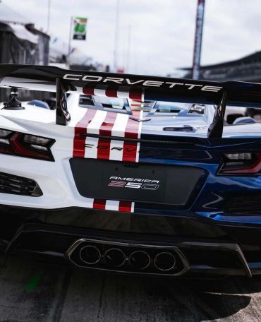 Rear view of a Corvette America 250 with racing stripes.