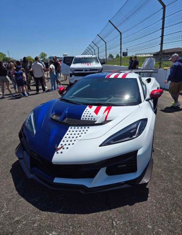 Sports car with American flag design on hood.
