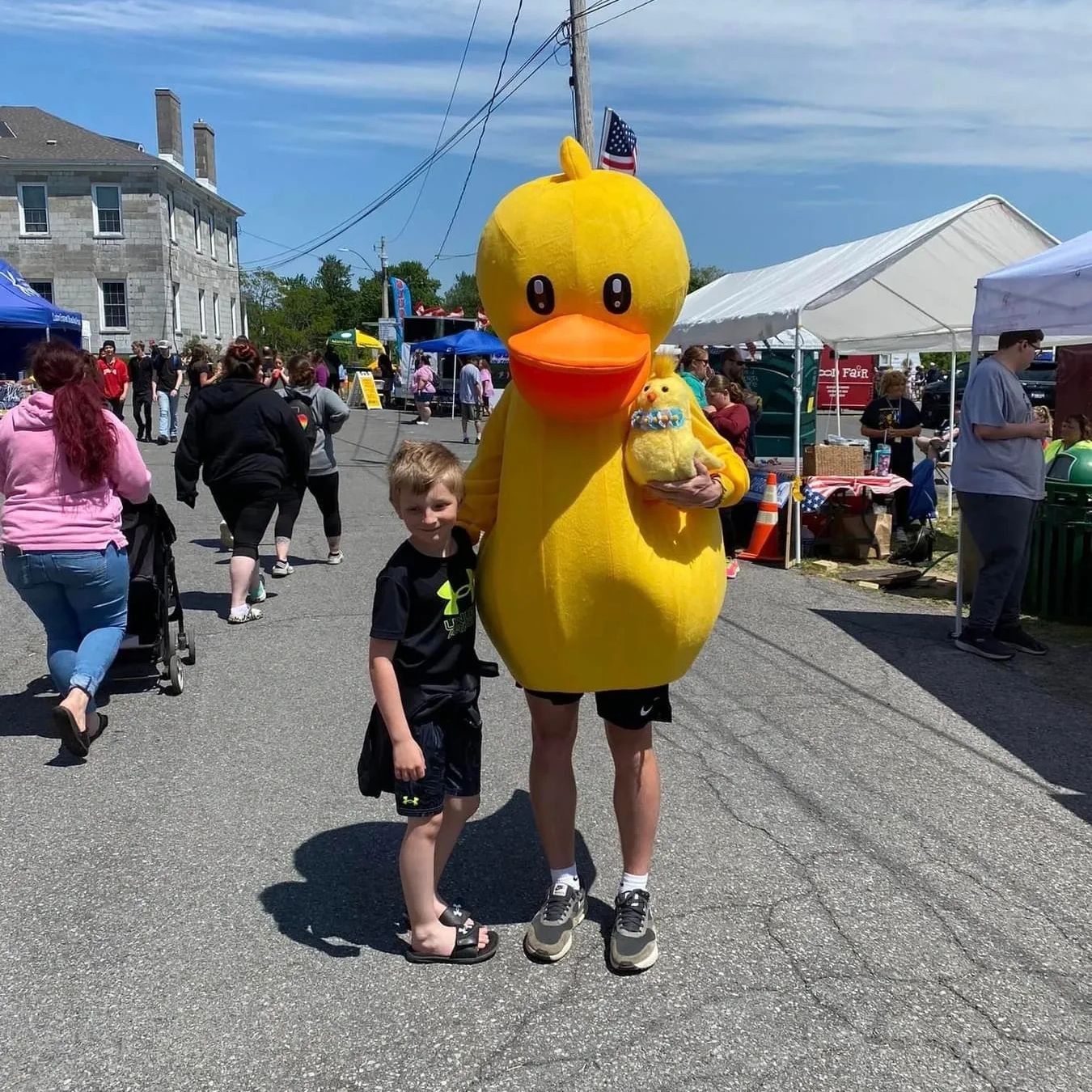 Duck Derby Mascot hugging a boy at the General Brown Days Festival