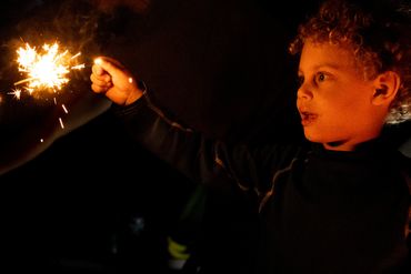 toddler playing with sparkler-documentary photographer