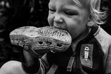 toddler eats dirty shoe- documentary day in the life photography