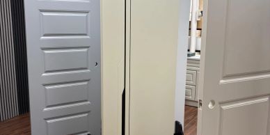 Display of several doors in a showroom with wooden floor.
