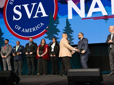 Group of people receiving awards on stage at an SVA event.