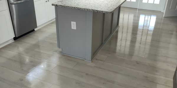 Bright modern kitchen with granite countertops and stainless steel appliances.