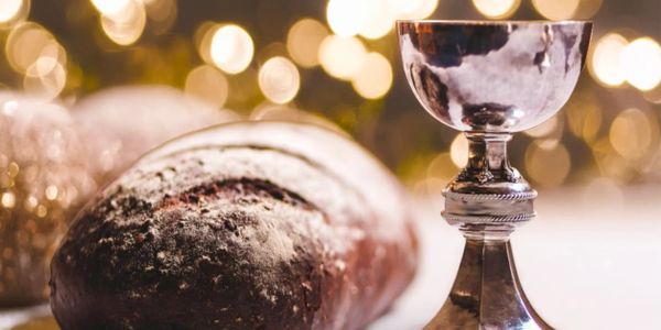 Traditional bread and chalice used in religious ceremonies.