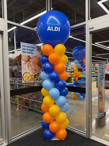Colorful ALDI balloon column inside a store entrance.