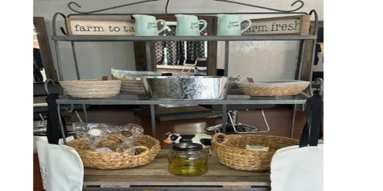 Rustic display with sunflowers, baskets, mugs, and farm-themed decor.