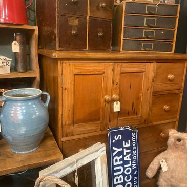 Antique wooden cabinets and vintage items in a rustic setting.