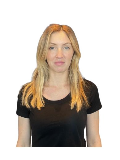 Blonde woman with long hair wearing a black t-shirt against white background.