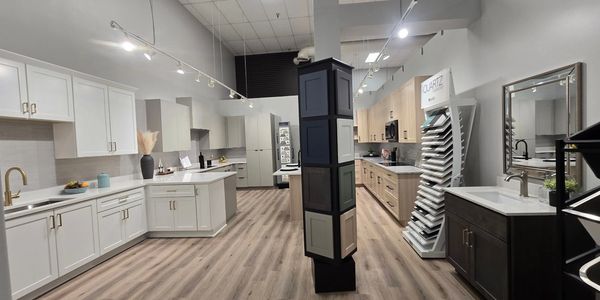 Modern kitchen showroom with various cabinet styles and finishes.