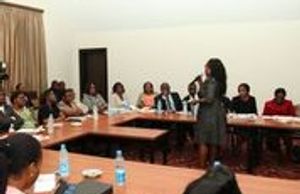  woman is giving a seminar to clients.