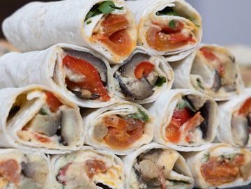 Mediterranean veggie wraps filled with grilled vegetables, hummus, and fresh greens