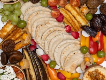 Mezze-style platter  including hummus, olives, falafel, pita bread, assorted dips