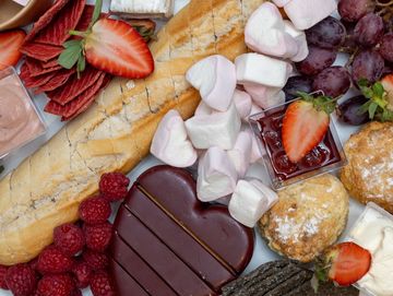 Love themed platter- heart-shaped chocolates, strawberries, assorted candies, and romantic decor.