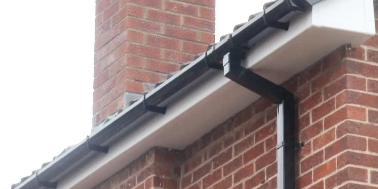white fascia and soffit with black square guttering installation