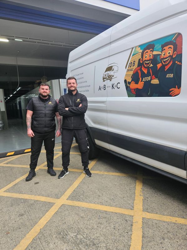 Kieran and Connor from A to B With K&C standing beside a branded removals van in Newcastle upon Tyne