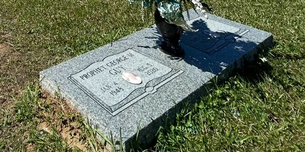 Gravestone of Prophet George M. Culp in a grassy cemetery.