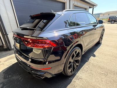 Black luxury SUV parked outside a building.