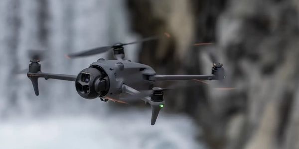 A drone flying near a waterfall.
