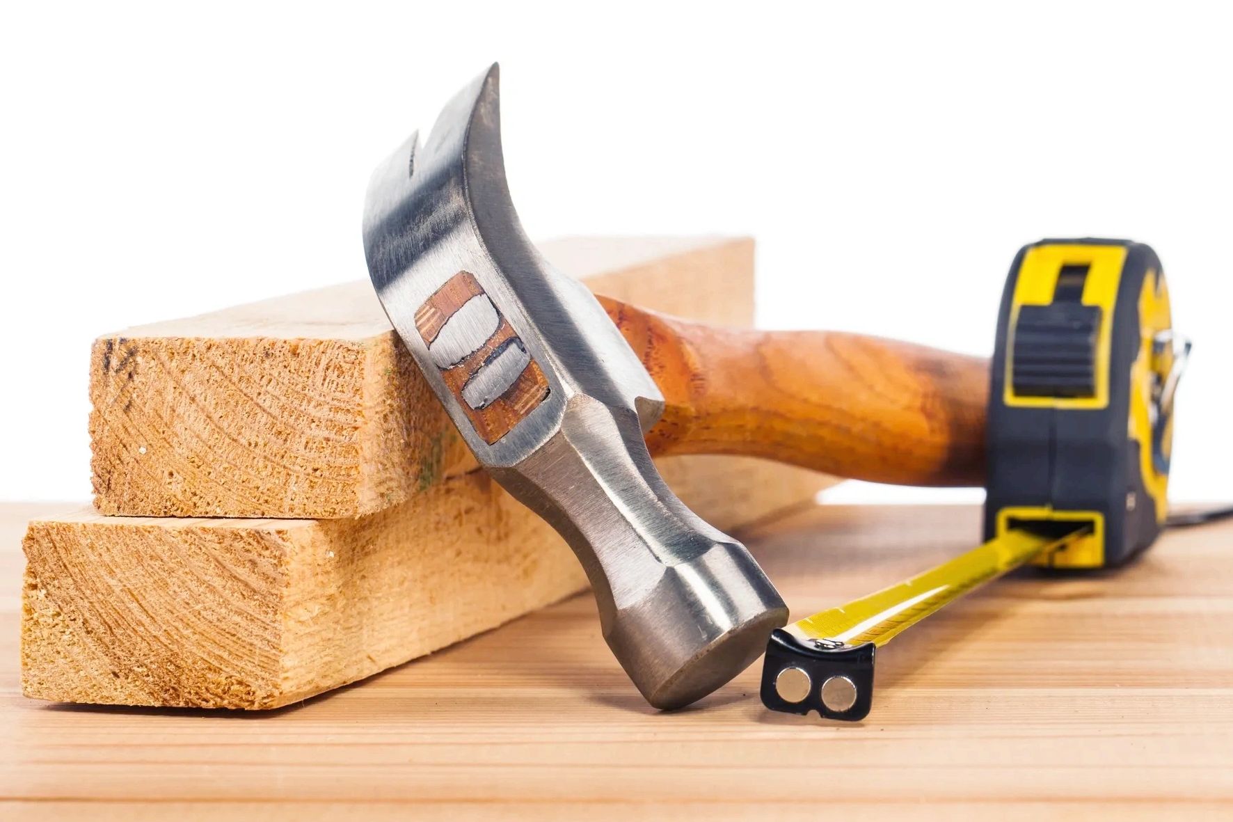 hammer, measuring tape, and wooden building materials