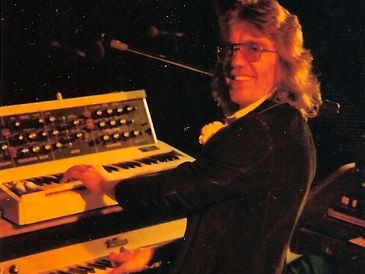 Man with long hair playing the keyboard