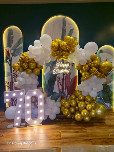 Elegant 70th birthday balloon decoration in gold & white by Bhardwaj Balloons. 🎈