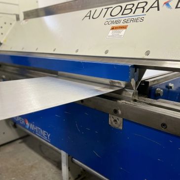 Industrial metal bending machine with sheet metal.