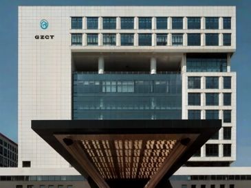 Modern office building with unique architectural design and GZCT logo.