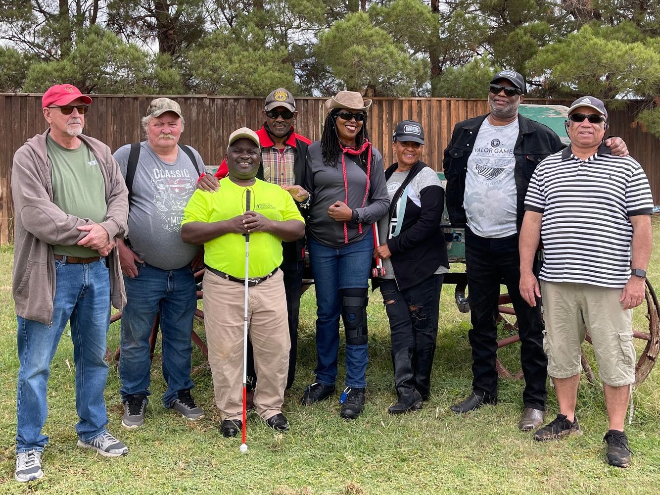 Image of smiling group of eight people lined up for photo in Texas