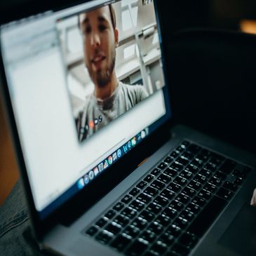 Laptop showing virtual meeting.