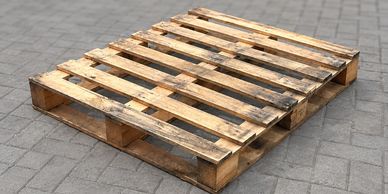 Wooden pallet on pavement.