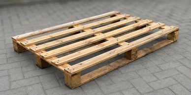 Wooden pallet on pavement.