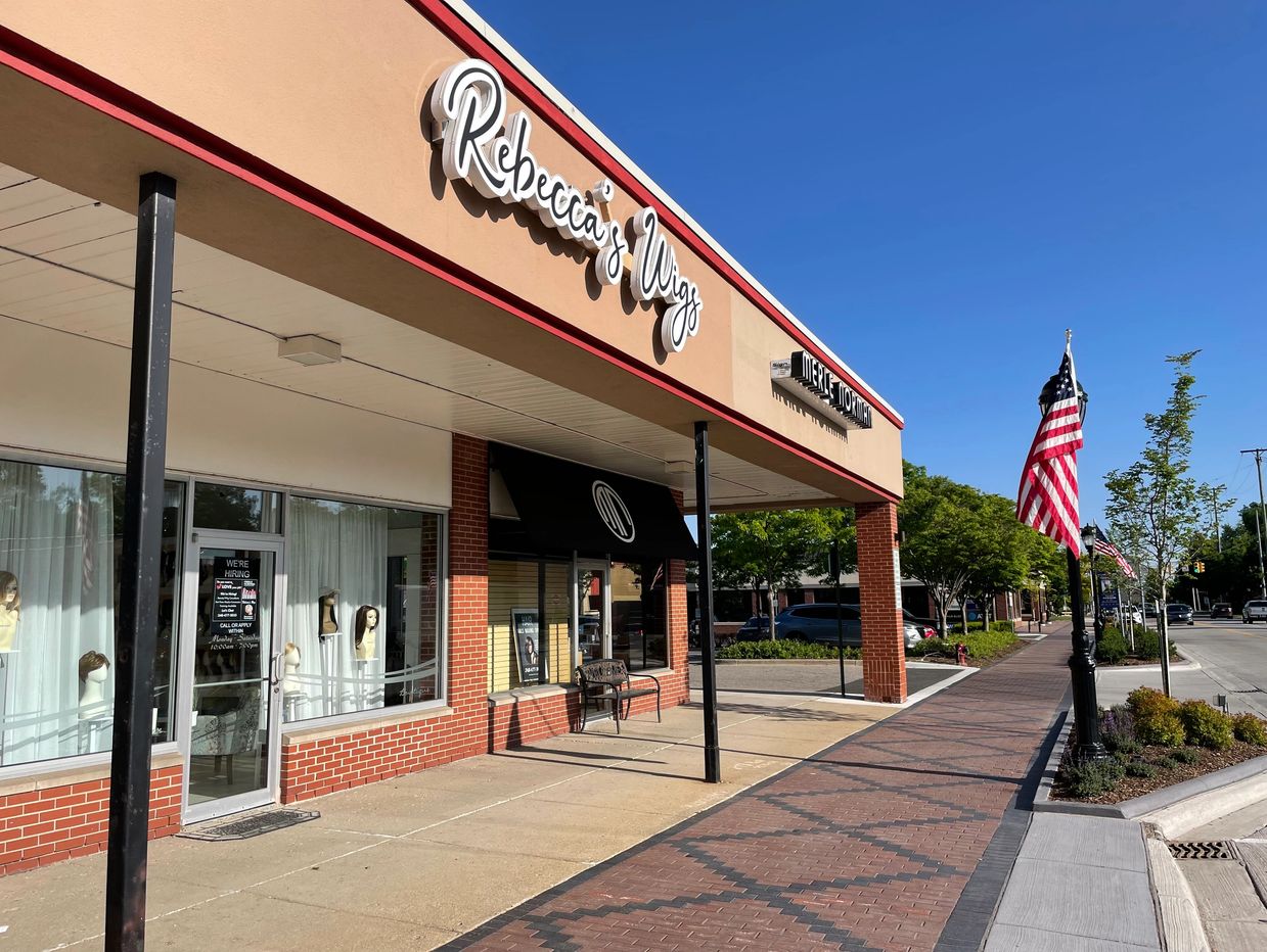 Rebecca's Wigs and Merle Norman Cosmetics Salon & Spa in Downtown Farmington with the USA flag