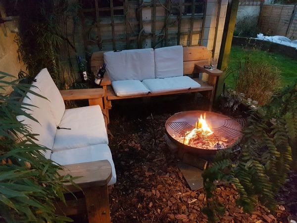 Rustic benches near a fireplace