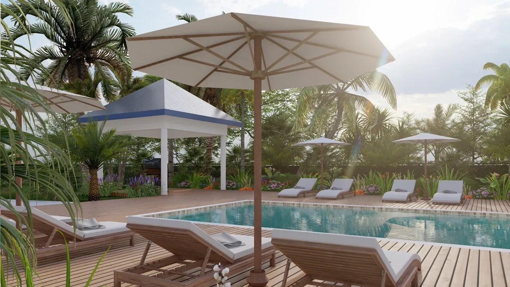 Elegant outdoor pool area with lounge chairs and umbrellas surrounded by tropical plants.