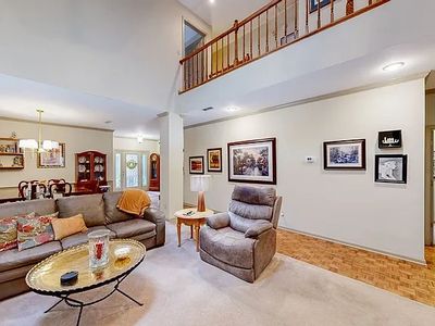 Spacious living room with cozy furniture and wall art.