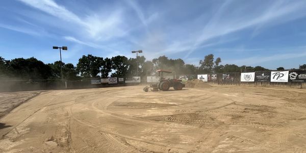 Tractor laser leveling sand arena