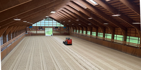 Indoor horse riding arena textile footing refresh and maintenance