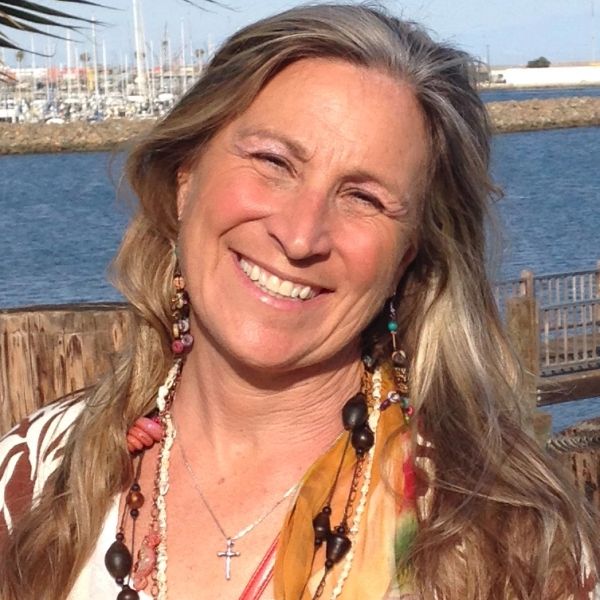 Smiling woman outdoors near water.