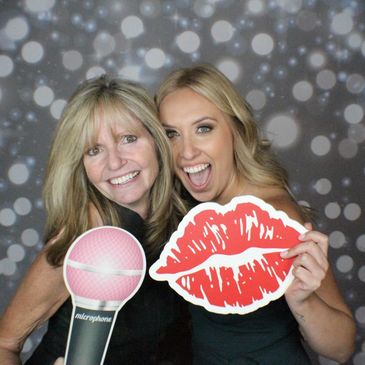 guests in photo booth with props