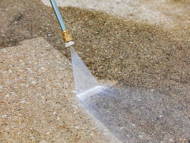 Pressure washing on old concrete floor.