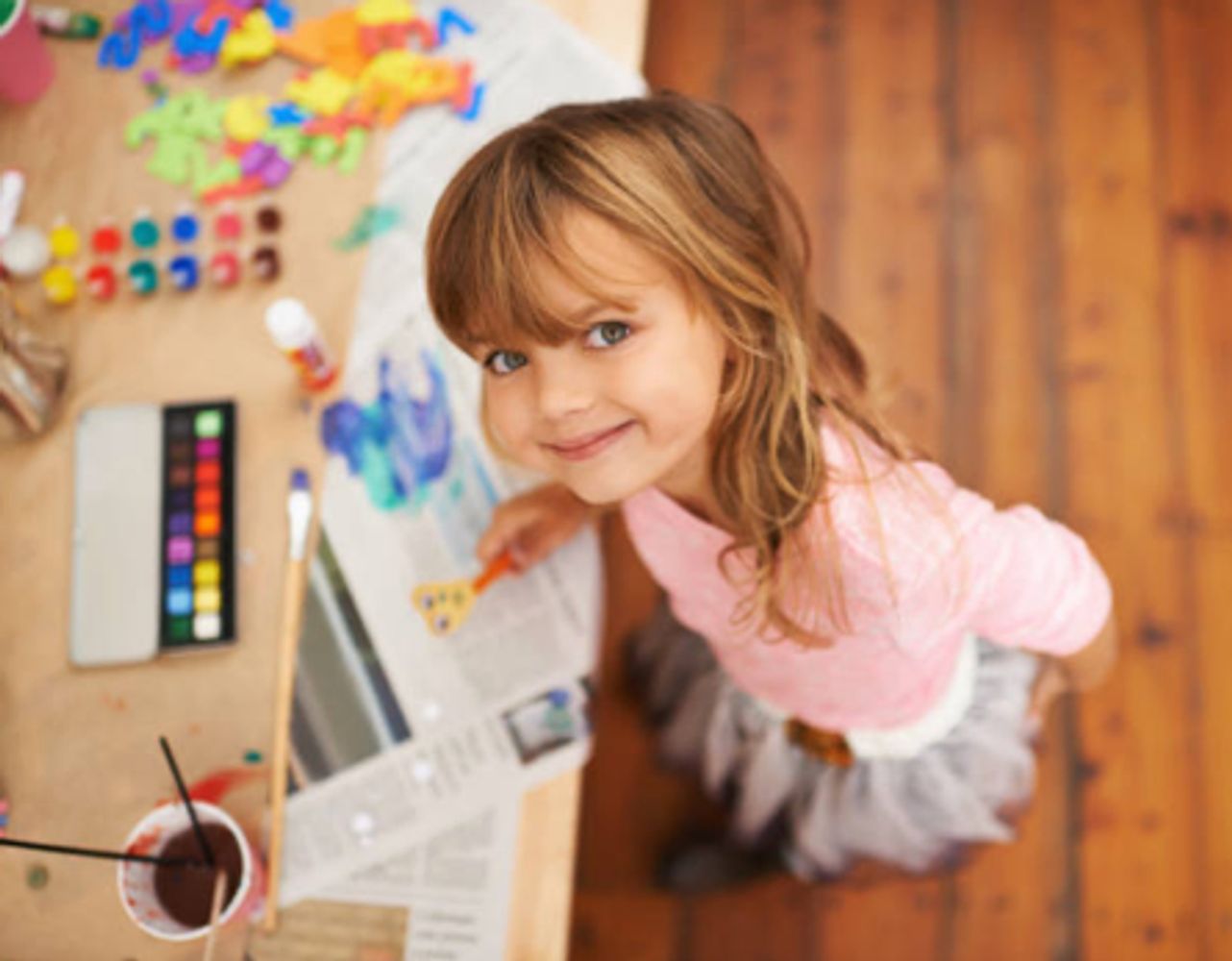 Young girl painting with watercolors