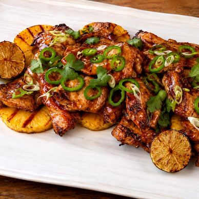 Glazed Huli Huli chicken with grilled pineapple, sliced jalapeños, scallions, cilantro, and charred 
