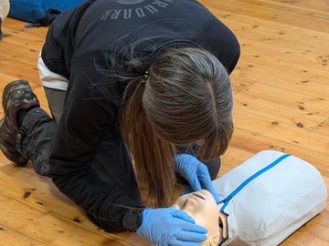A first aider preparing to give rescue breaths to a paediatric casualty