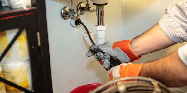 Mike uncloging a bathroom sink drain in Tracy 